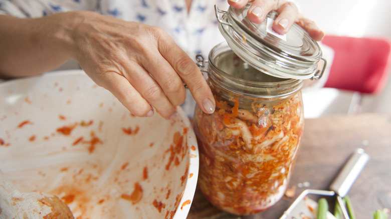 Άτομο που κλείνει το βάζο του kimchi δίπλα στο Prep Bowl